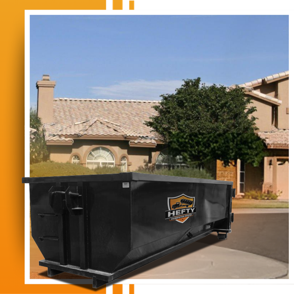 A dumpster placed in front of a house