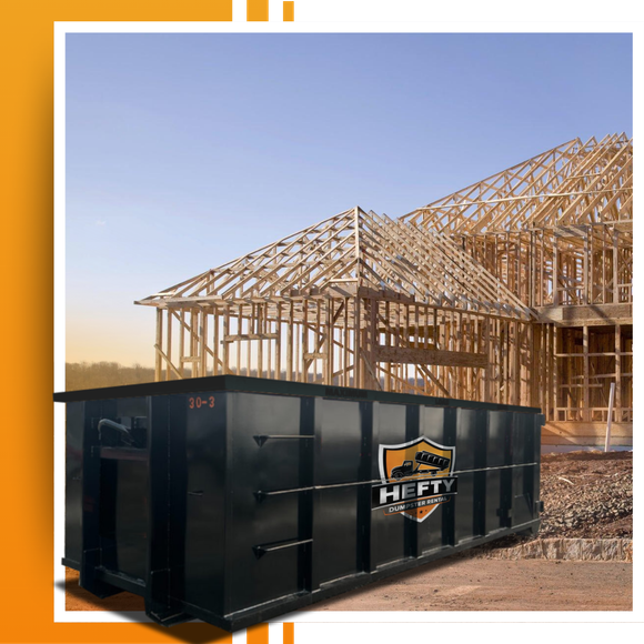 A dumpster placed in front of a constuction site