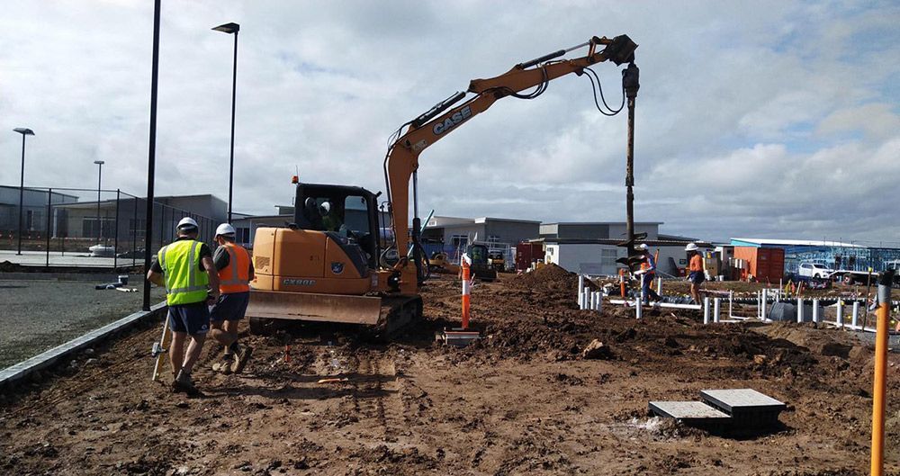 A Group of Construction Workers Are Working on A Construction Site — Polson Construction in Kedron, QLD