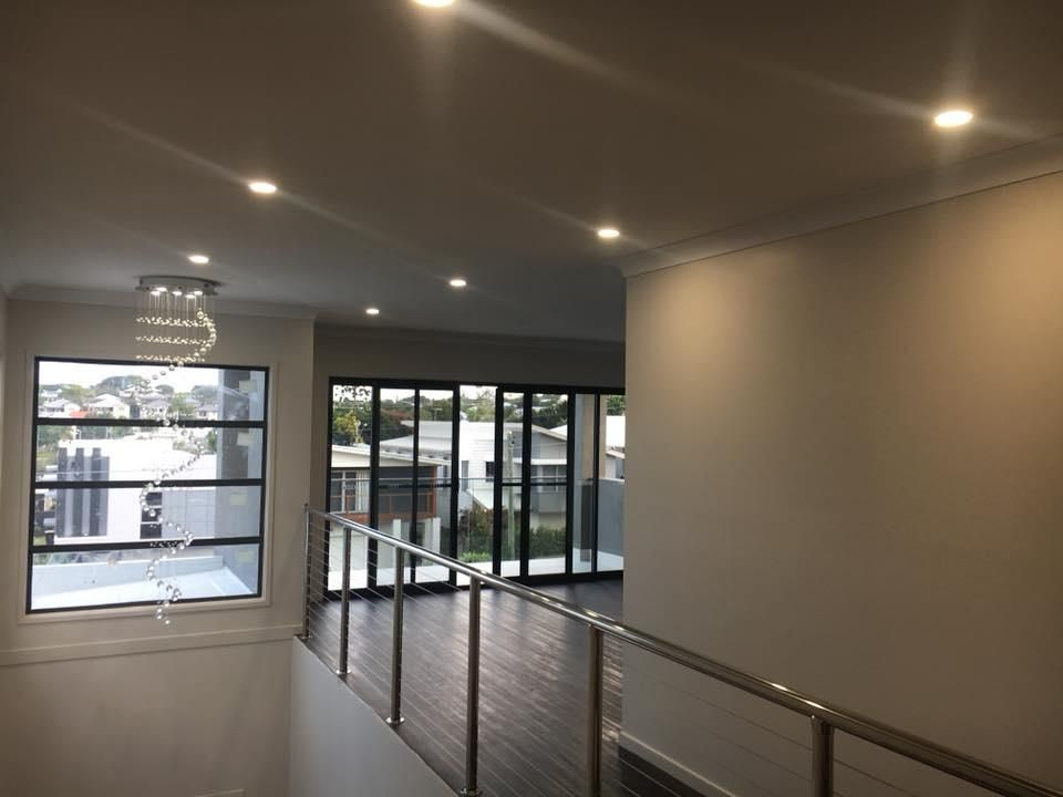 A Staircase with A Railing and A Large Window — Polson Construction in Kedron, QLD