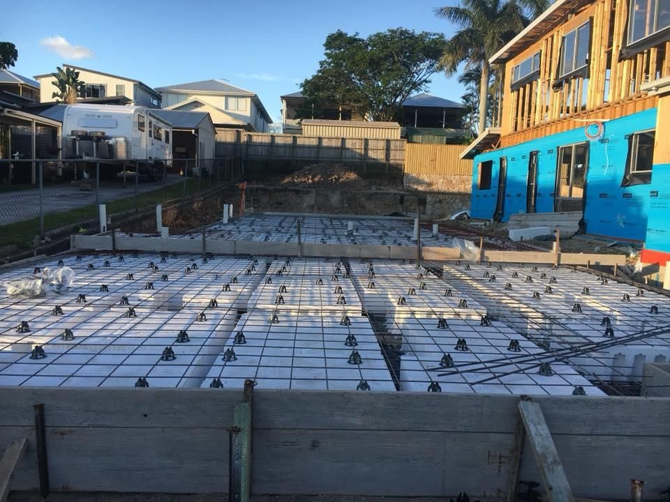 A Building Under Construction with A Lot of Concrete on The Ground — Polson Construction in Kedron, QLD