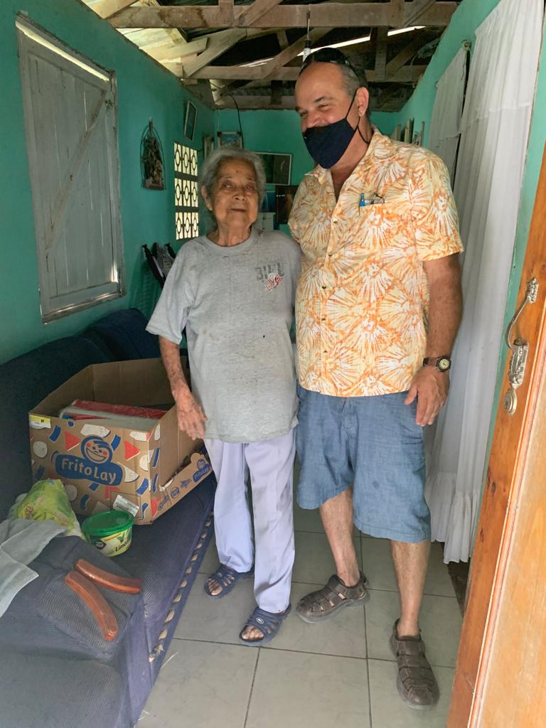 A man and a woman are standing next to each other in a room.