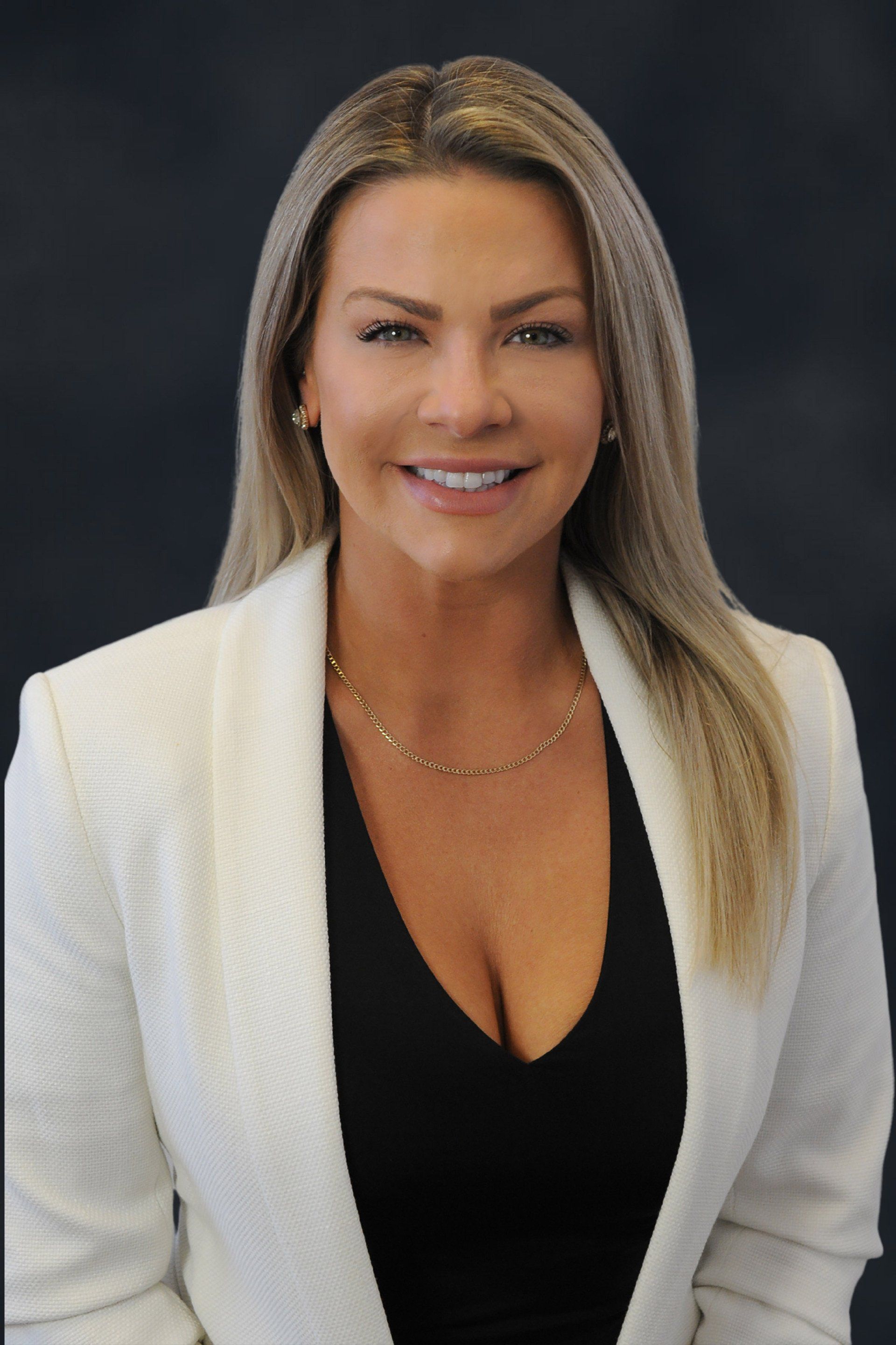 A woman is wearing a white jacket and a black top