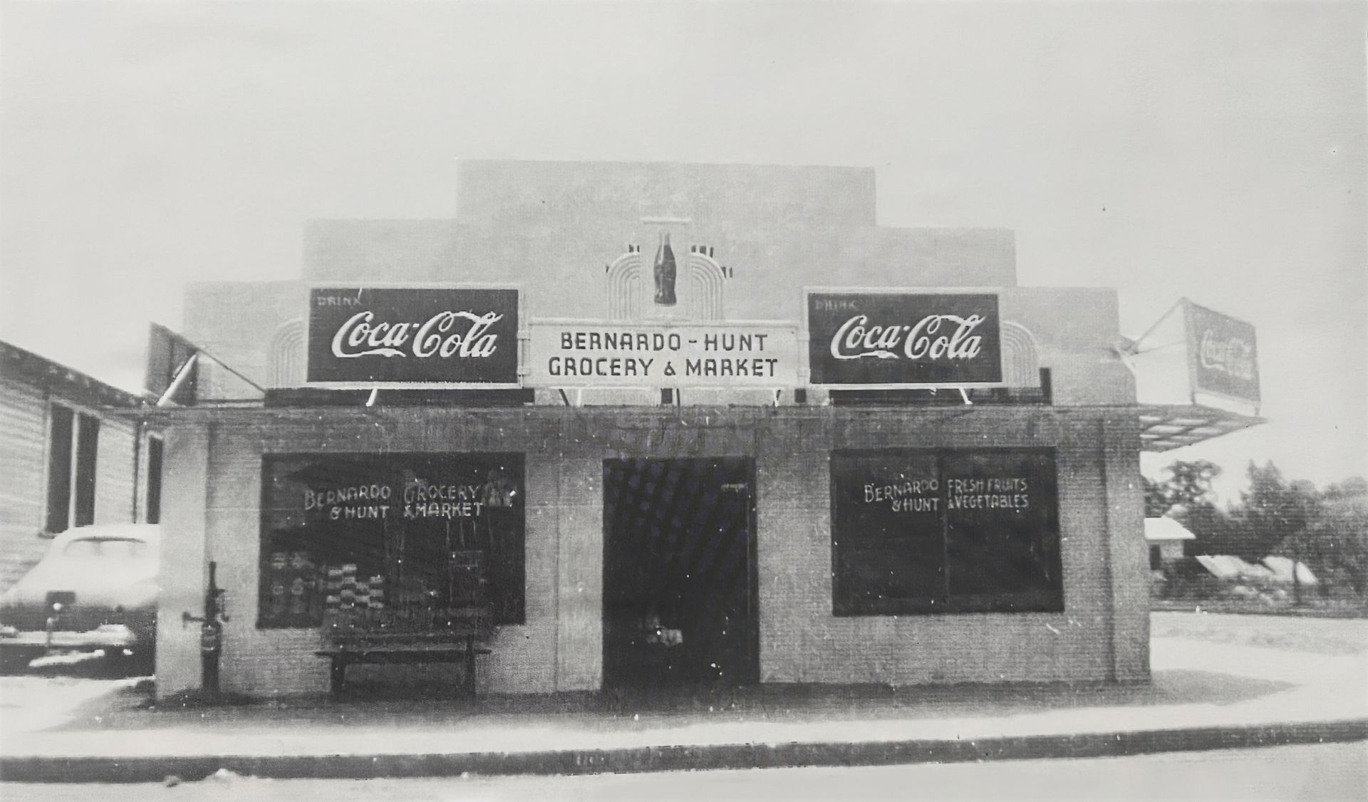A black and white photo of a coca cola store