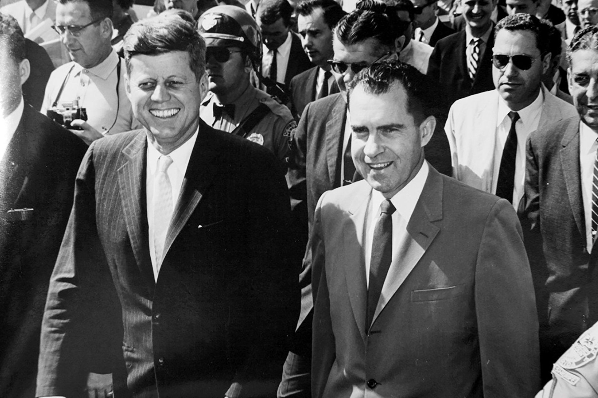 A black and white photo of two men in suits and ties