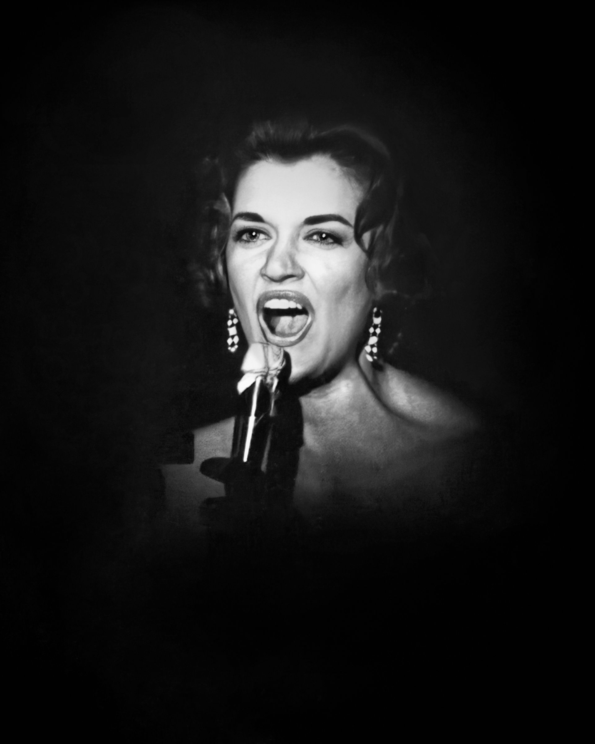 A woman is singing into a microphone in a black and white photo.