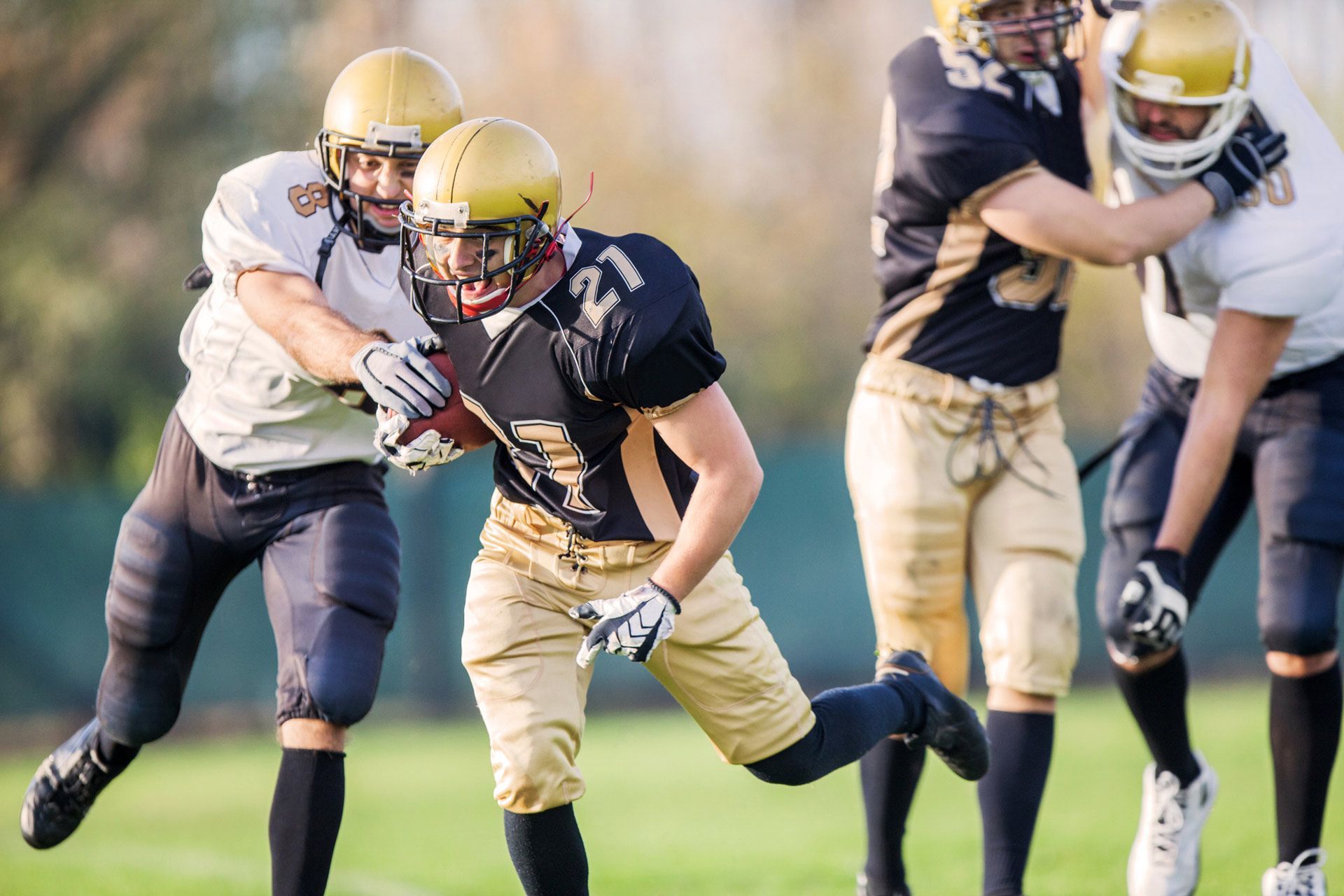 A group of football players are playing a game on a field