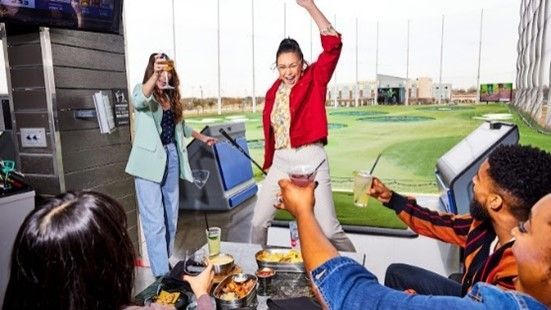 A group of people are having a party at a golf course.