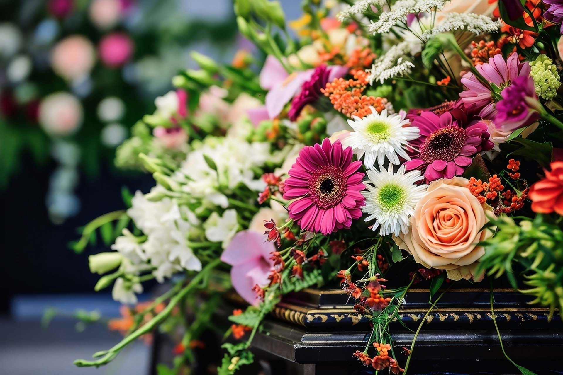 A coffin is decorated with flowers for a funeral.