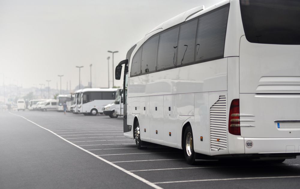 A White Bus Is Parked in A Parking Lot — G & D Ross Bus Charters In Magnolia, QLD
