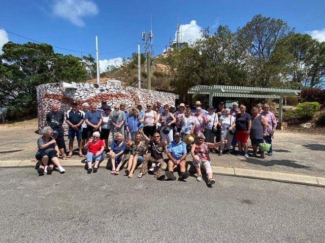 — G & D Ross Bus Charters In Magnolia, QLDA group of people are posing for a picture on the side of the road.