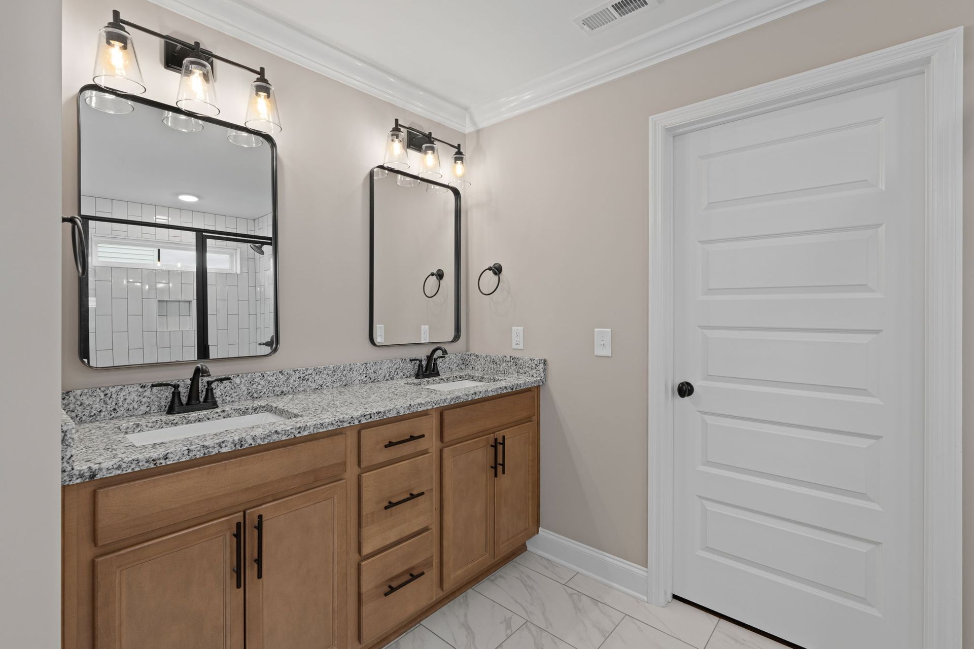 A bathroom with two sinks and two mirrors.