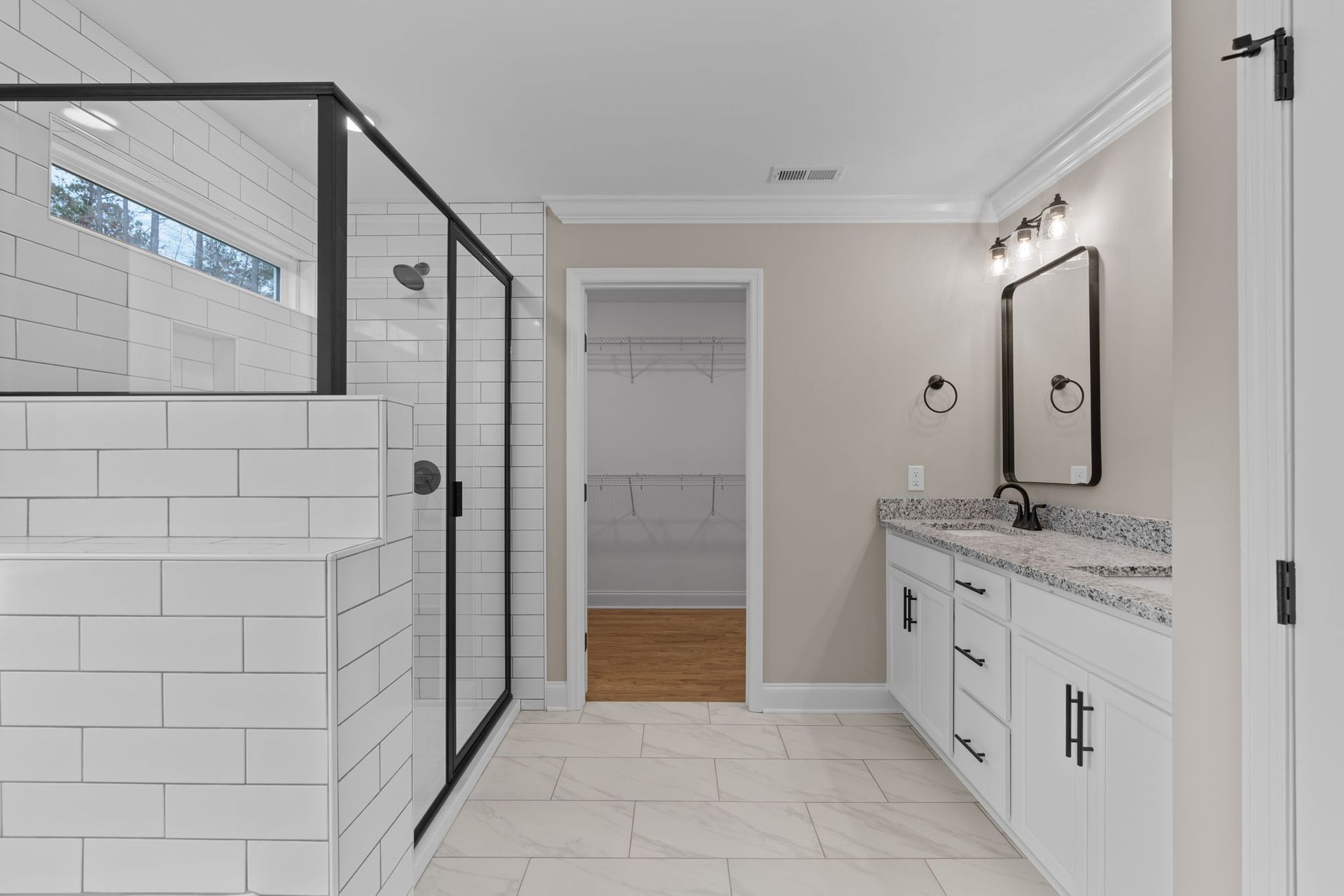 A bathroom with a walk in shower , sink , and mirror.