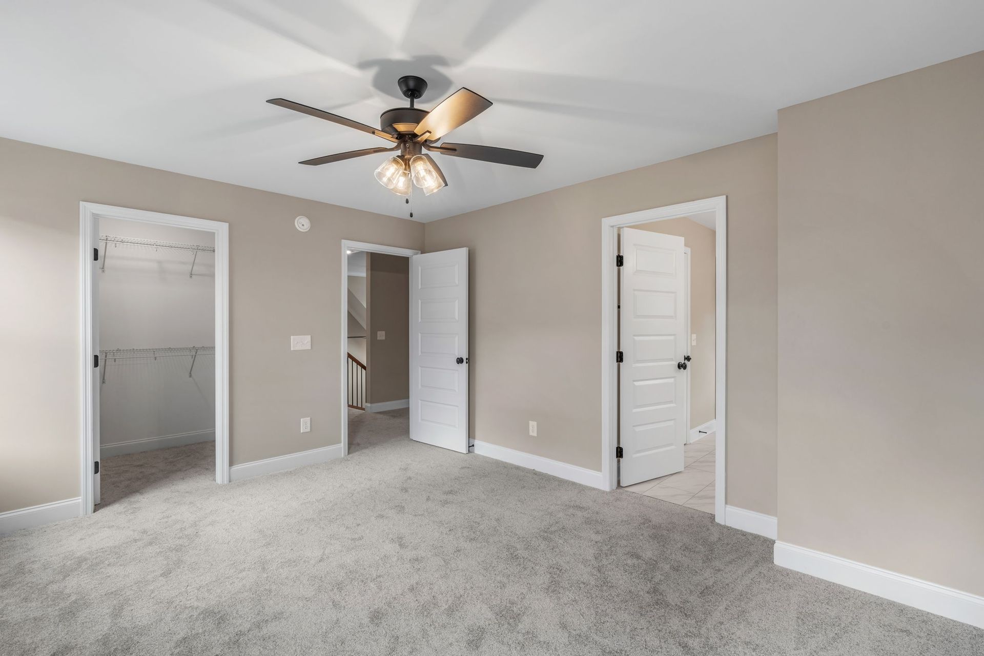 There is a ceiling fan in the middle of the room.