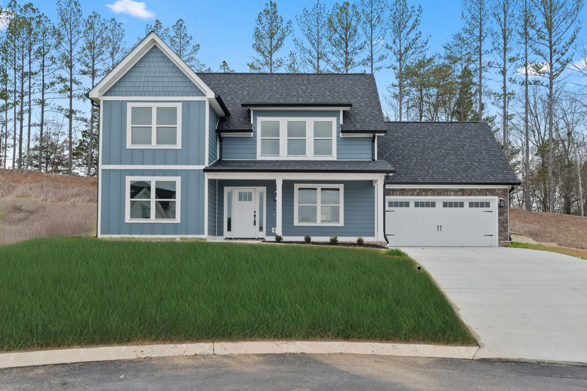 A blue house with a gray roof and white trim