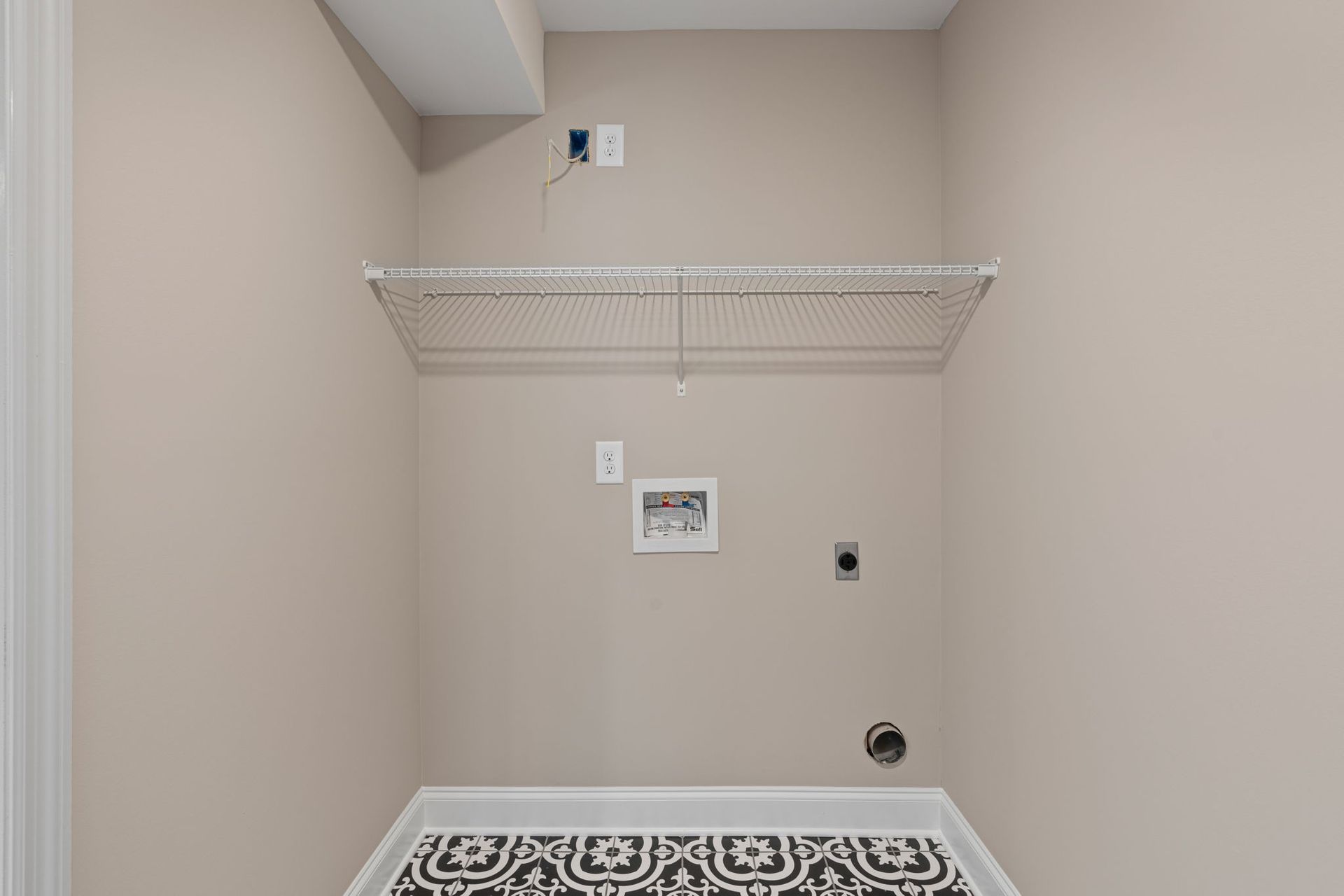 A laundry room in a house with a washer and dryer.