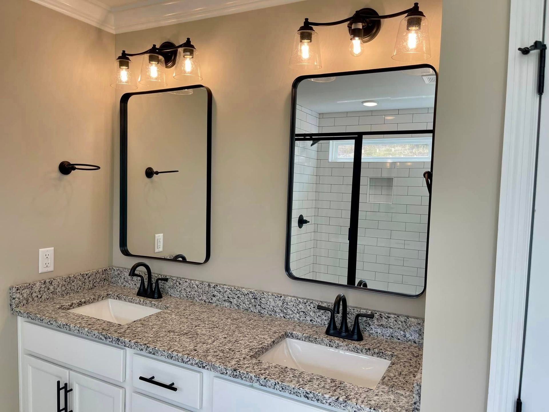 A bathroom with two sinks and two mirrors.