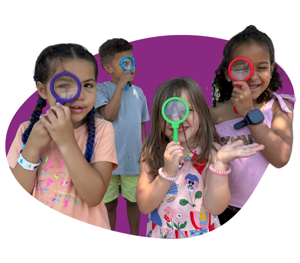Four children holding colorful magnifying glasses over their faces, against a purple backdrop.