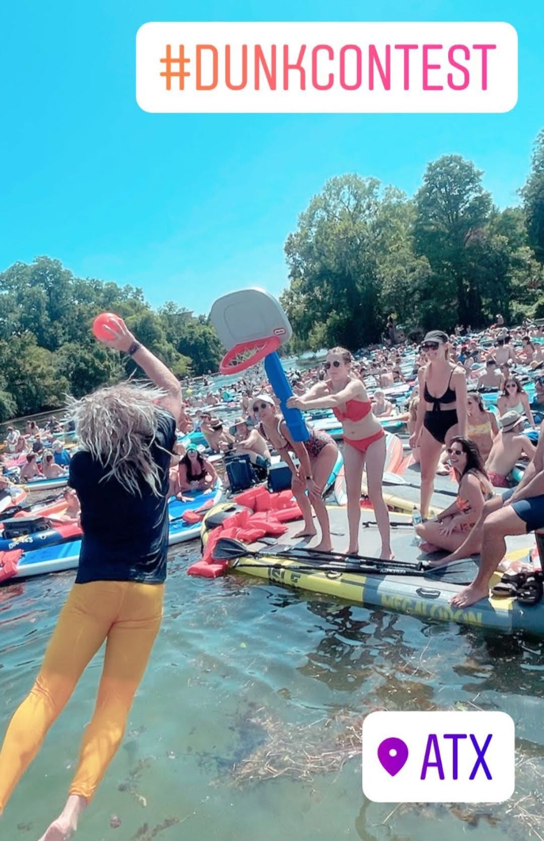 #DunkContest at a sunny lakeside crowd, with people on floaties and one person jumping into the water; ATX