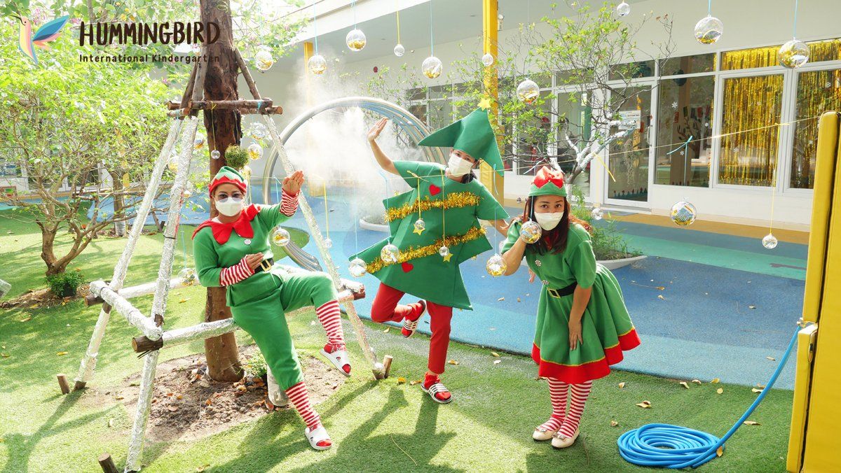 A group of people dressed as elves are playing with soap bubbles.