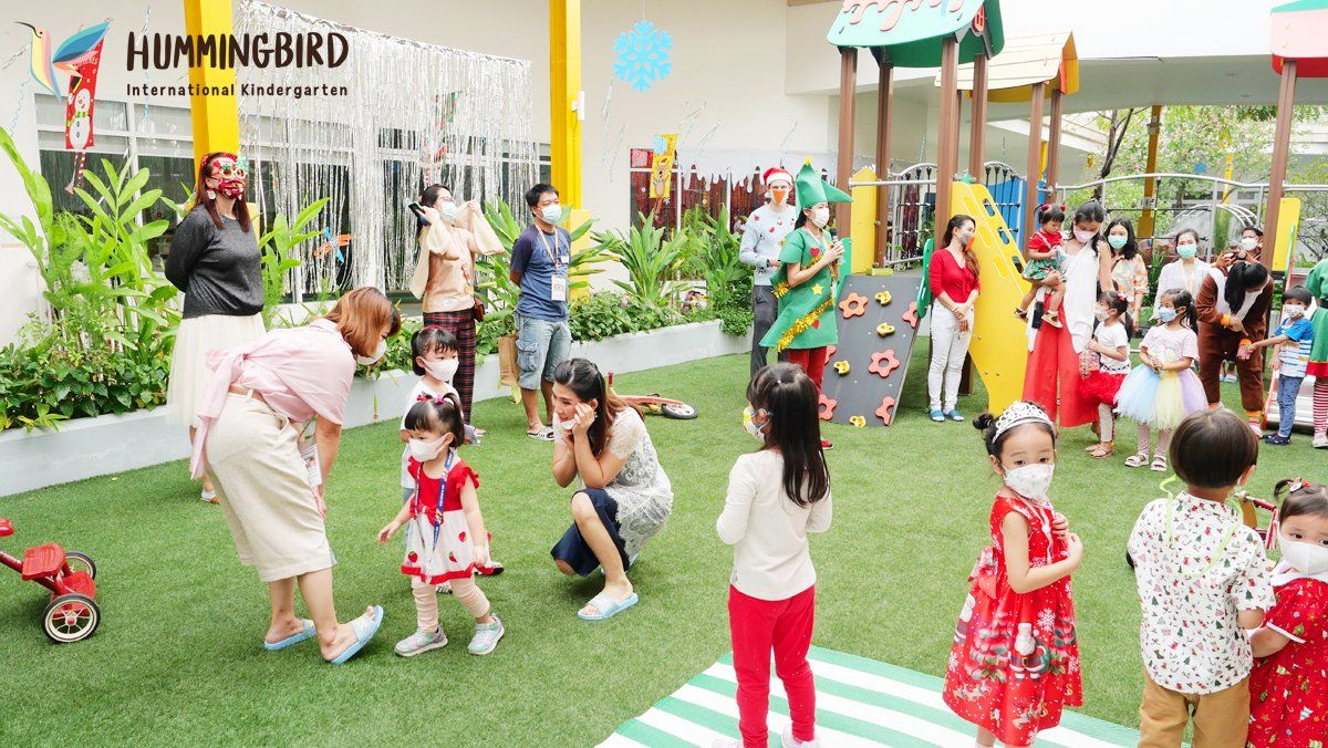 A group of children wearing face masks are playing in a playground.
