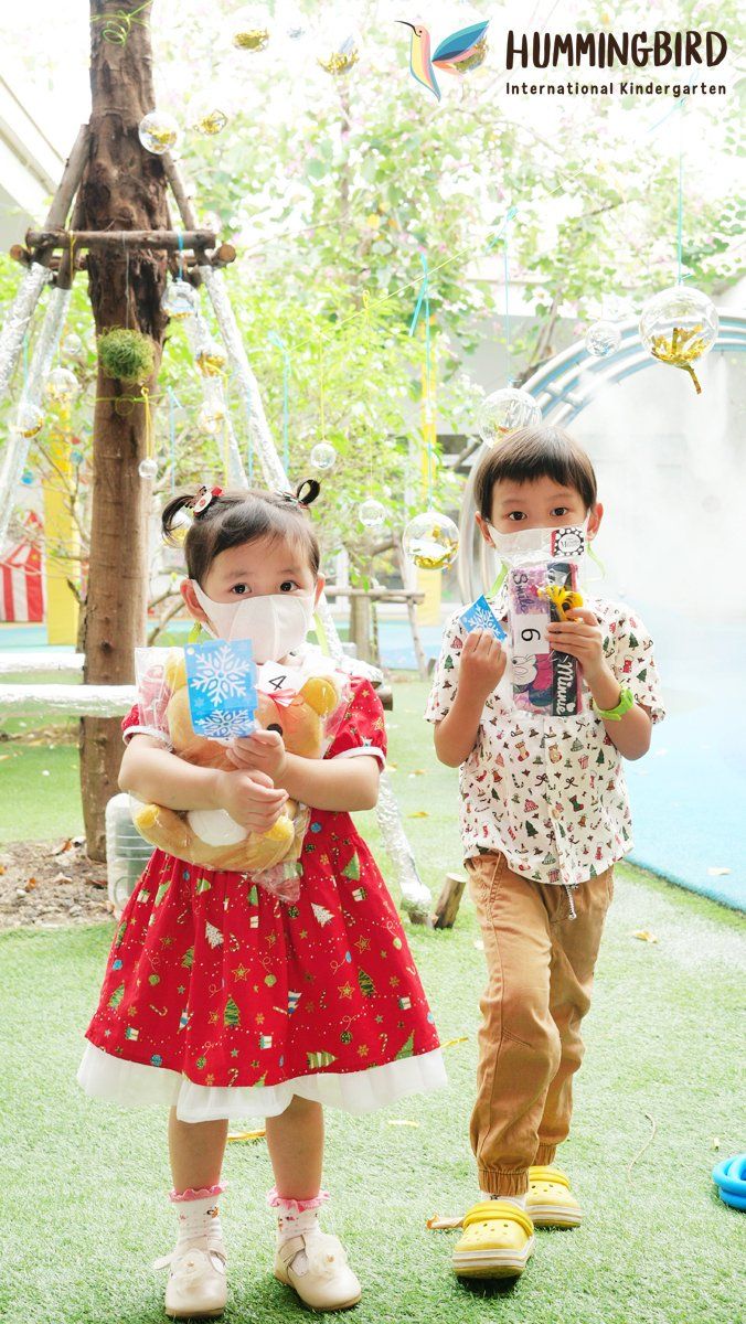 A boy and a girl wearing face masks are standing next to each other.