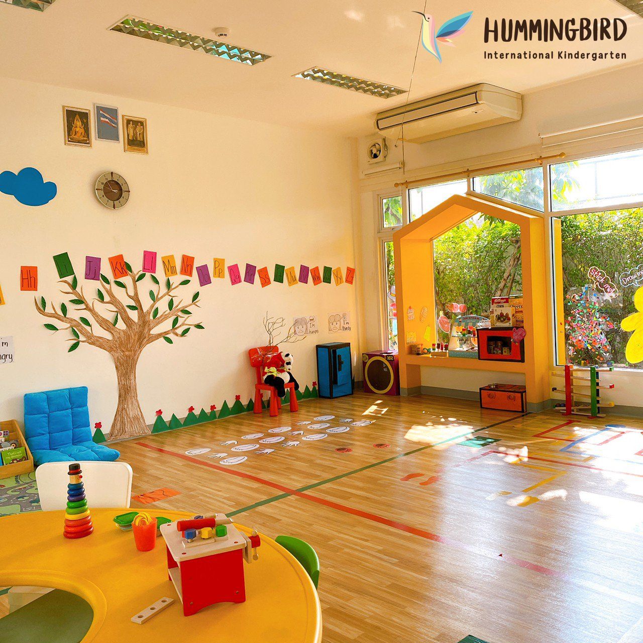 A room with a hummingbird logo on the wall