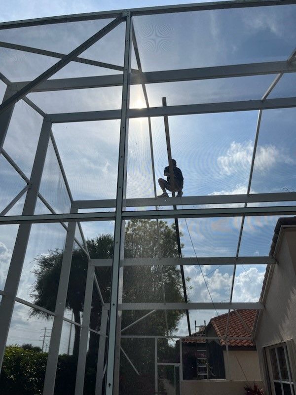 A Man On Rooftop Fixing A Screen | Lantana, Florida, United States | Phoenix Screen Company