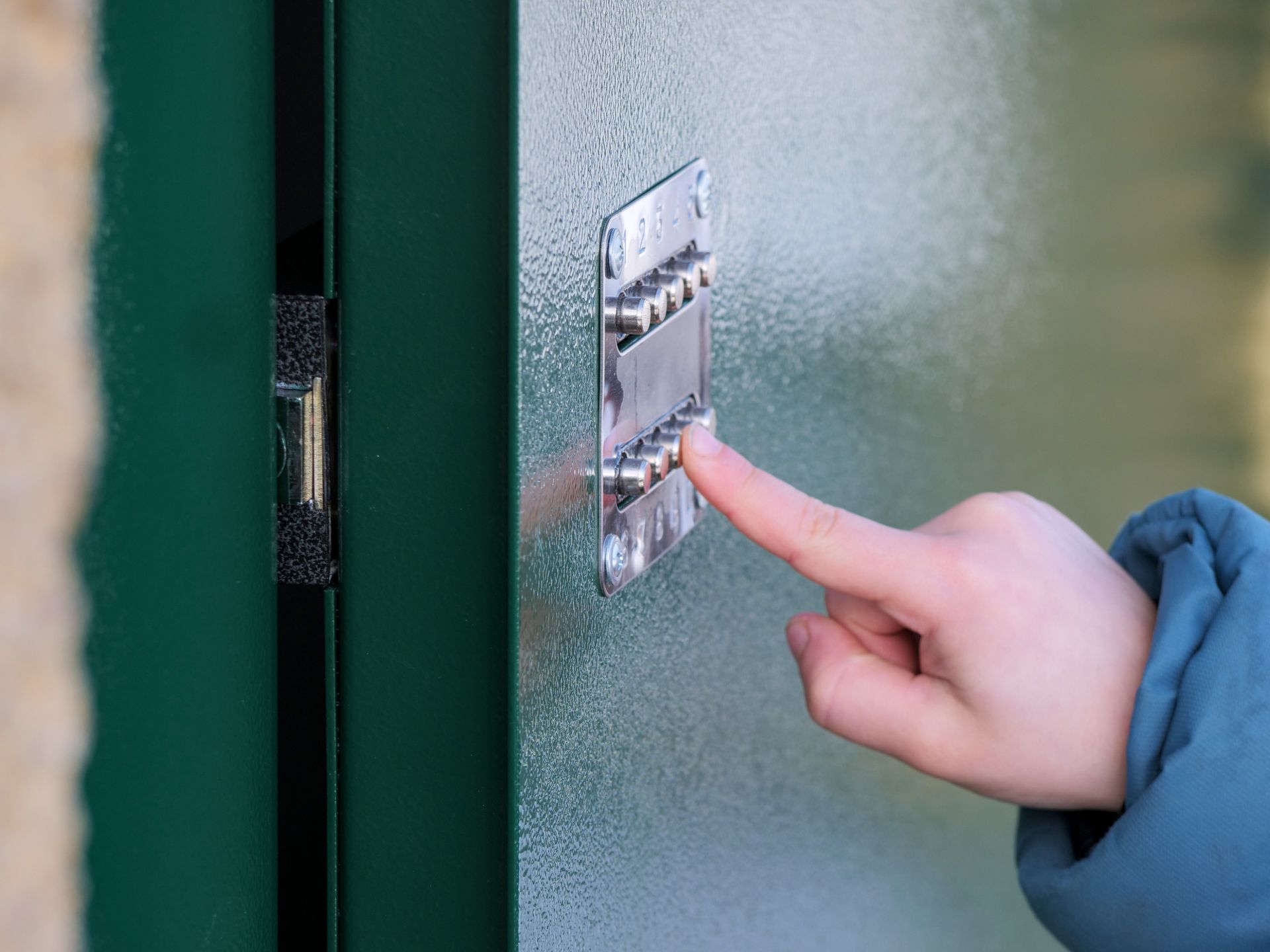 Commercial locksmith installing a high-security lock on a business door.