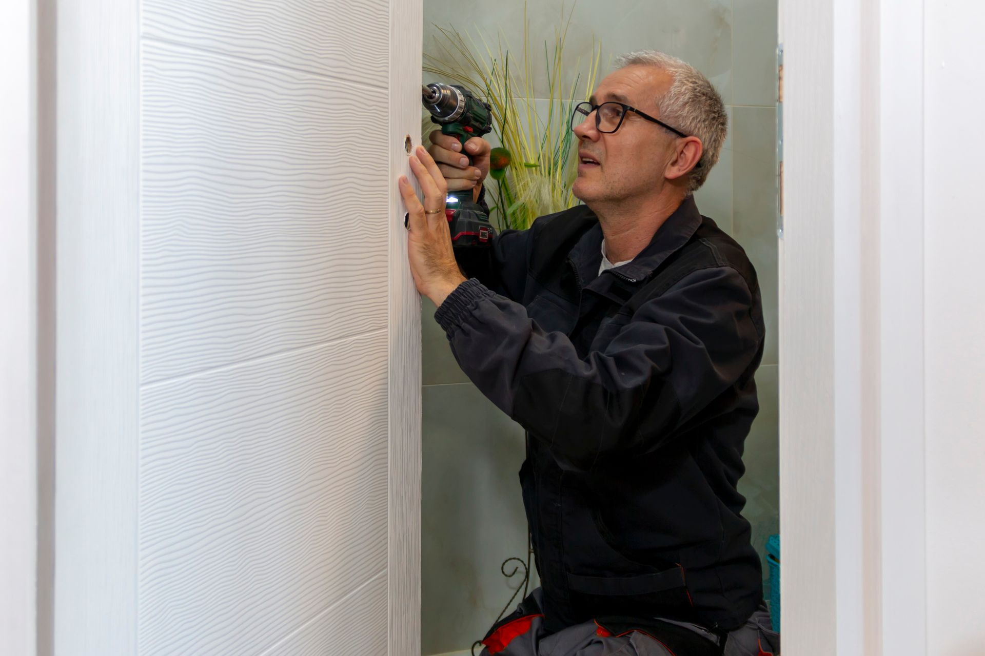 A man is installing a new lock.