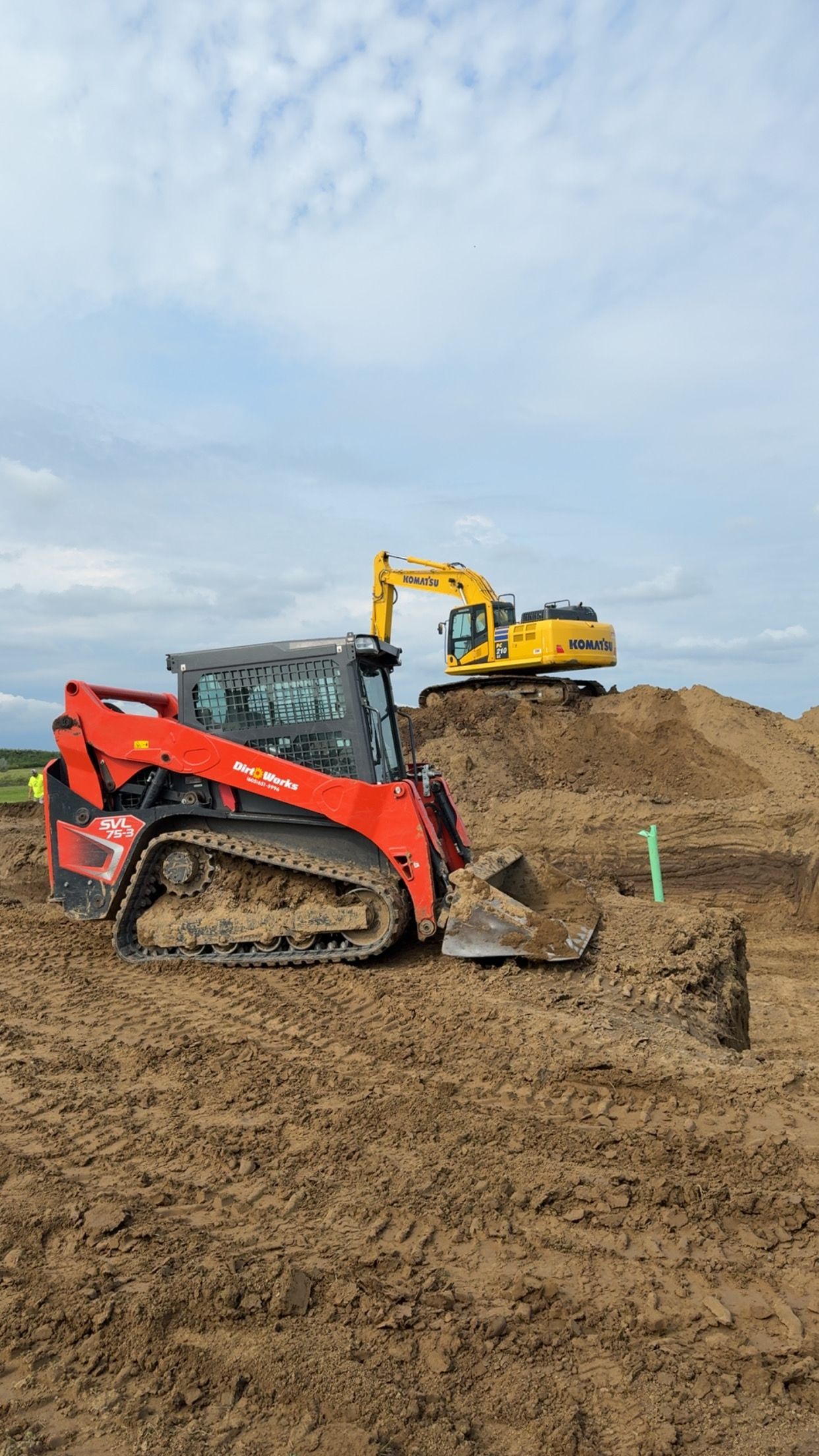 A large excavator is demolishing a building.