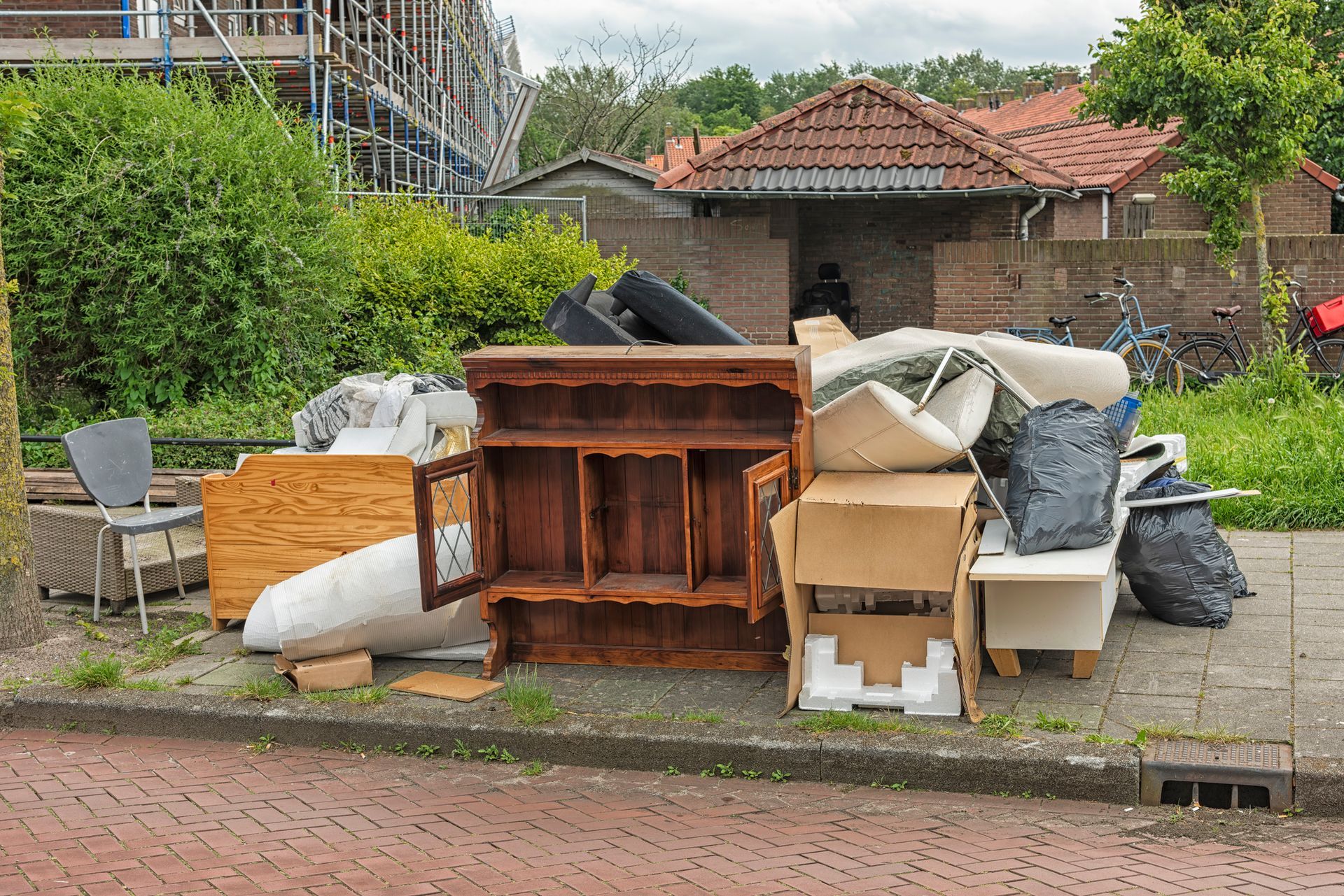 A pile of junk is sitting on the side of the road.