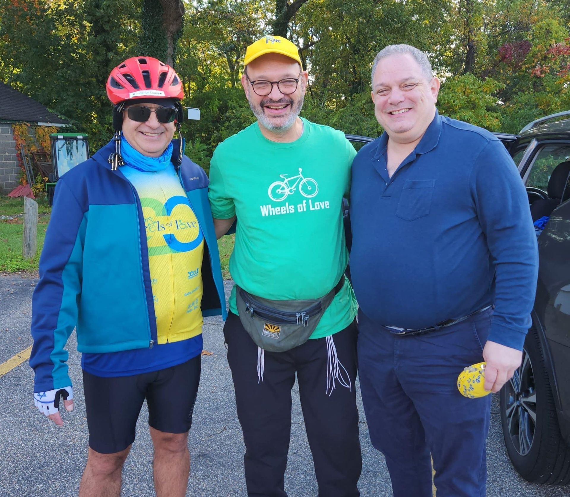 Three men posing for a picture with one wearing a green shirt that says walk a mile