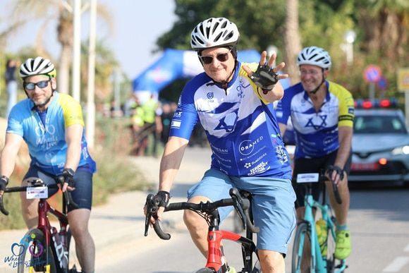 A group of men are riding bicycles down a street.