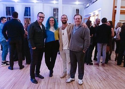 A group of people are posing for a picture in a room.