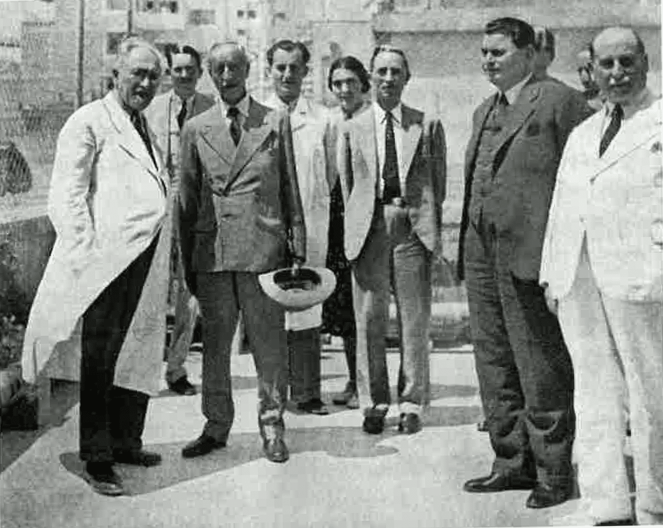 A black and white photo of a group of men standing next to each other