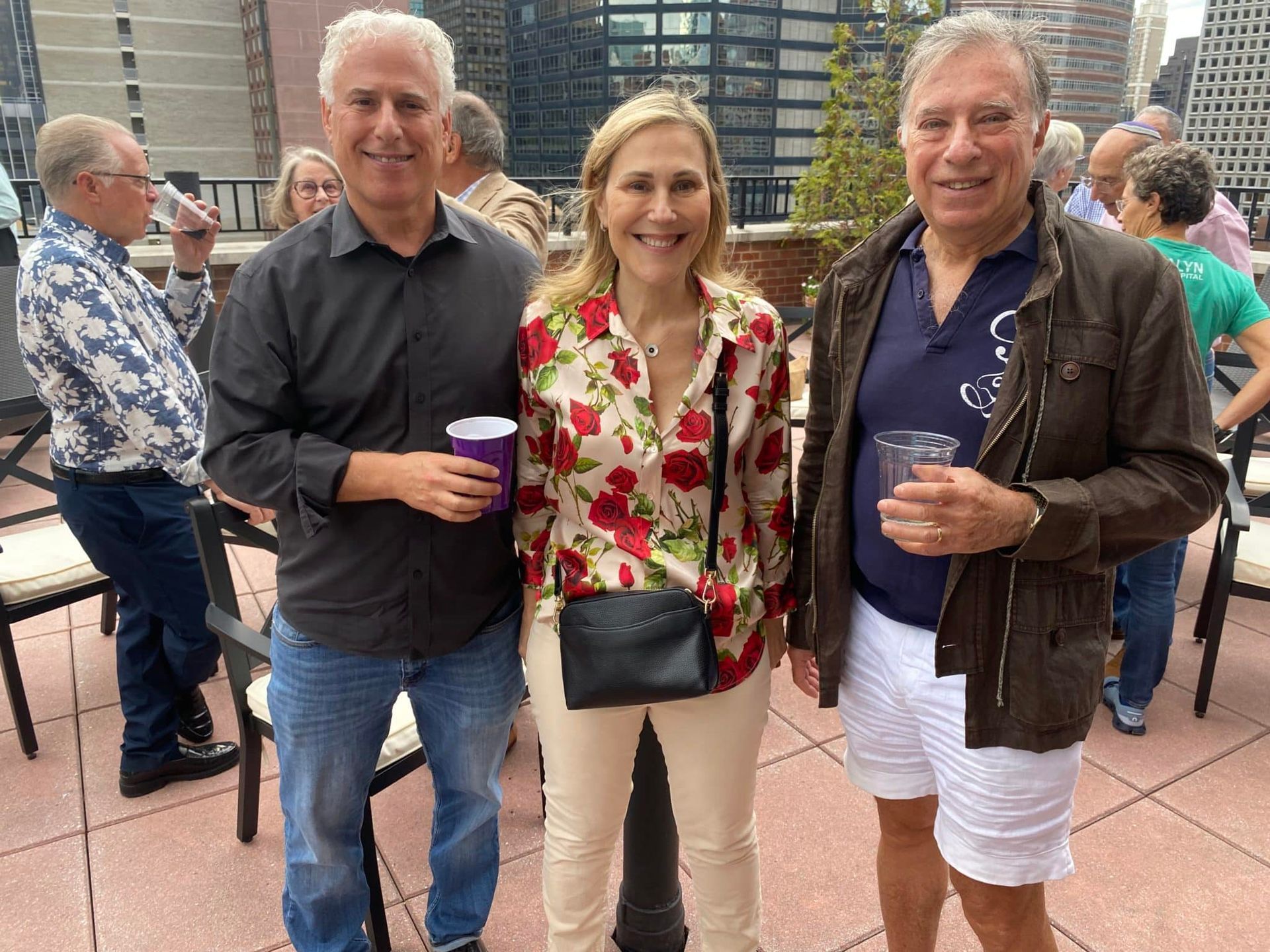 A group of people are standing next to each other on a patio.
