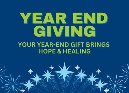 A blue background with fireworks and the words year end giving