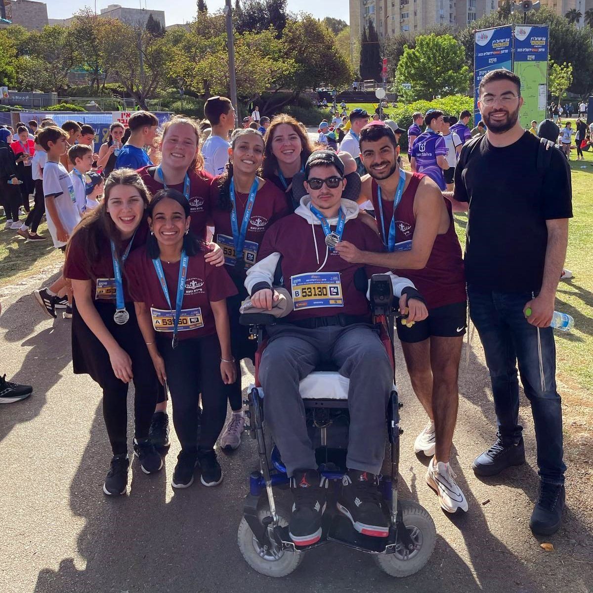 A group of people standing around a man in a wheelchair