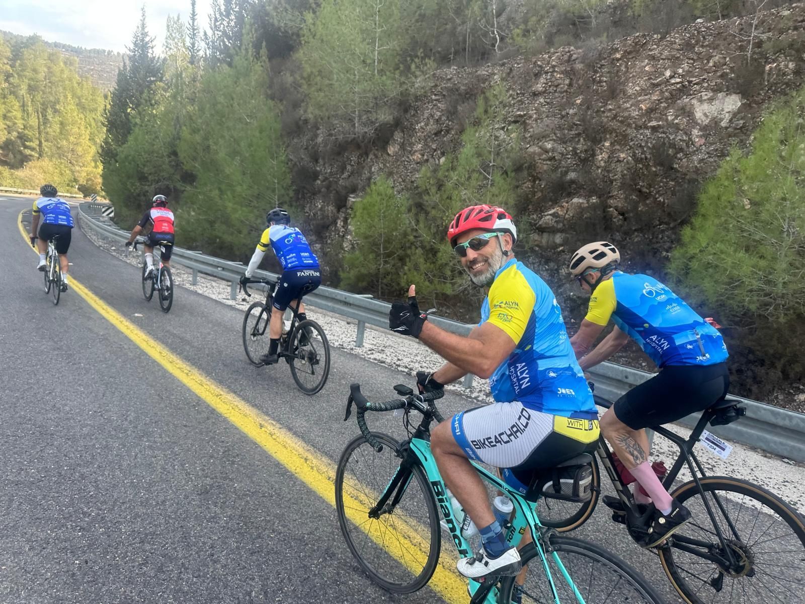 A group of people are riding bicycles down a road.