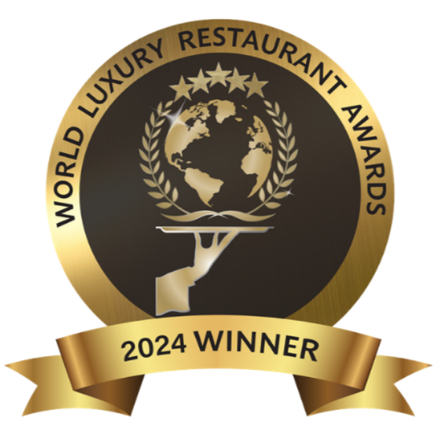 A circular gold and black emblem for the 2024 World Luxury Restaurant Awards, featuring a globe held on a silver platter.