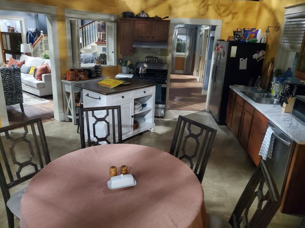 A kitchen with a table and chairs in it