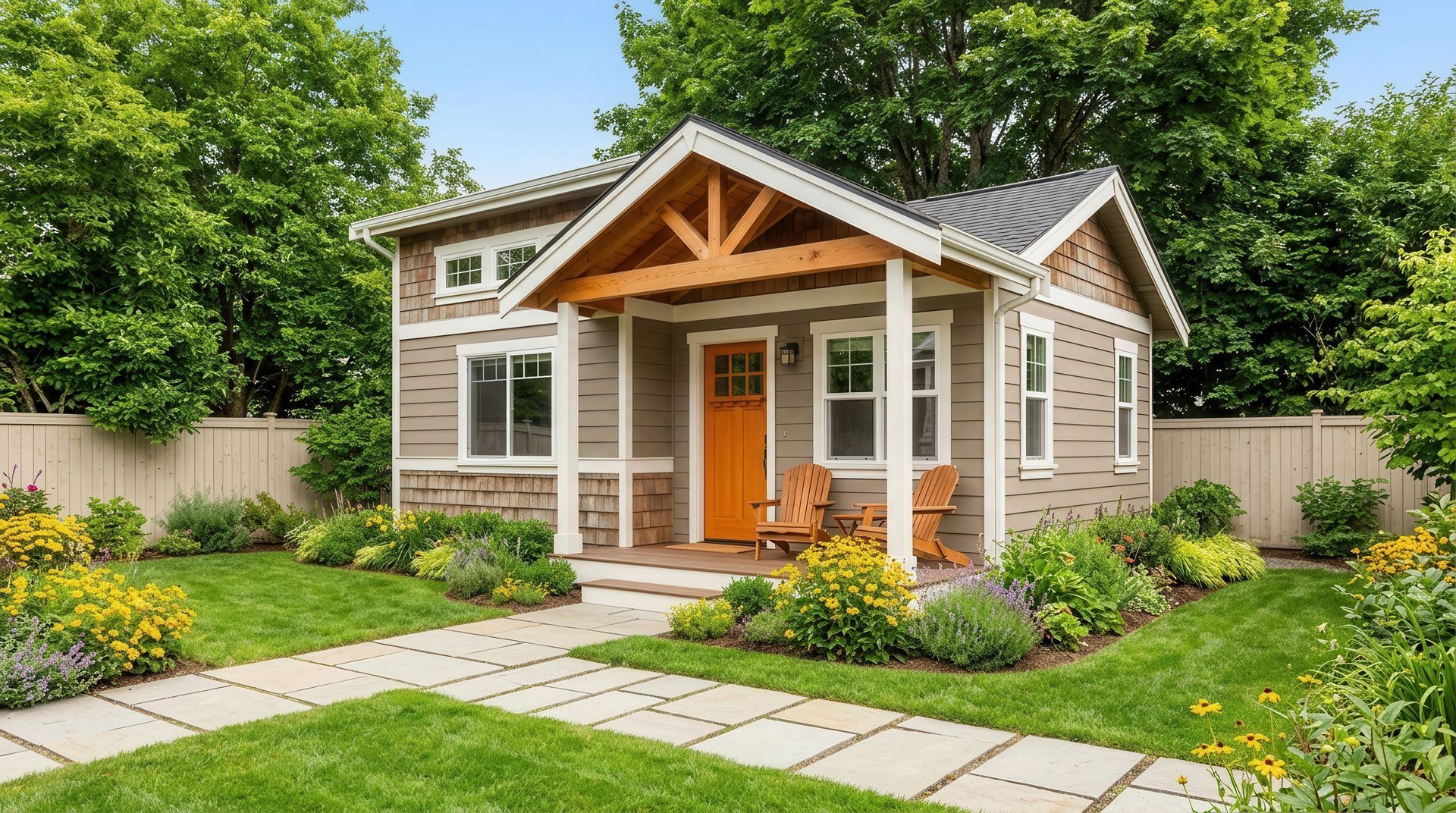 Small beige cottage with a front porch, orange door, and landscaped garden under green trees.