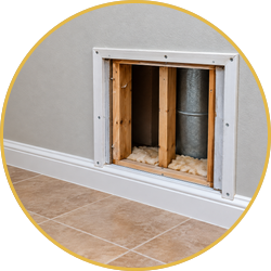 Unfinished wall opening with exposed framing and ductwork above a tiled floor and white baseboard trim