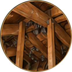 Close-up of a wooden lattice structure with angled beams and metal bolts in a circular frame
