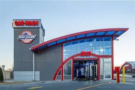 A car wash with a lot of windows and a red roof.