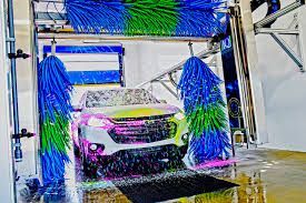 A car is being washed in a car wash.