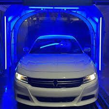 A white car is going through a car wash tunnel.