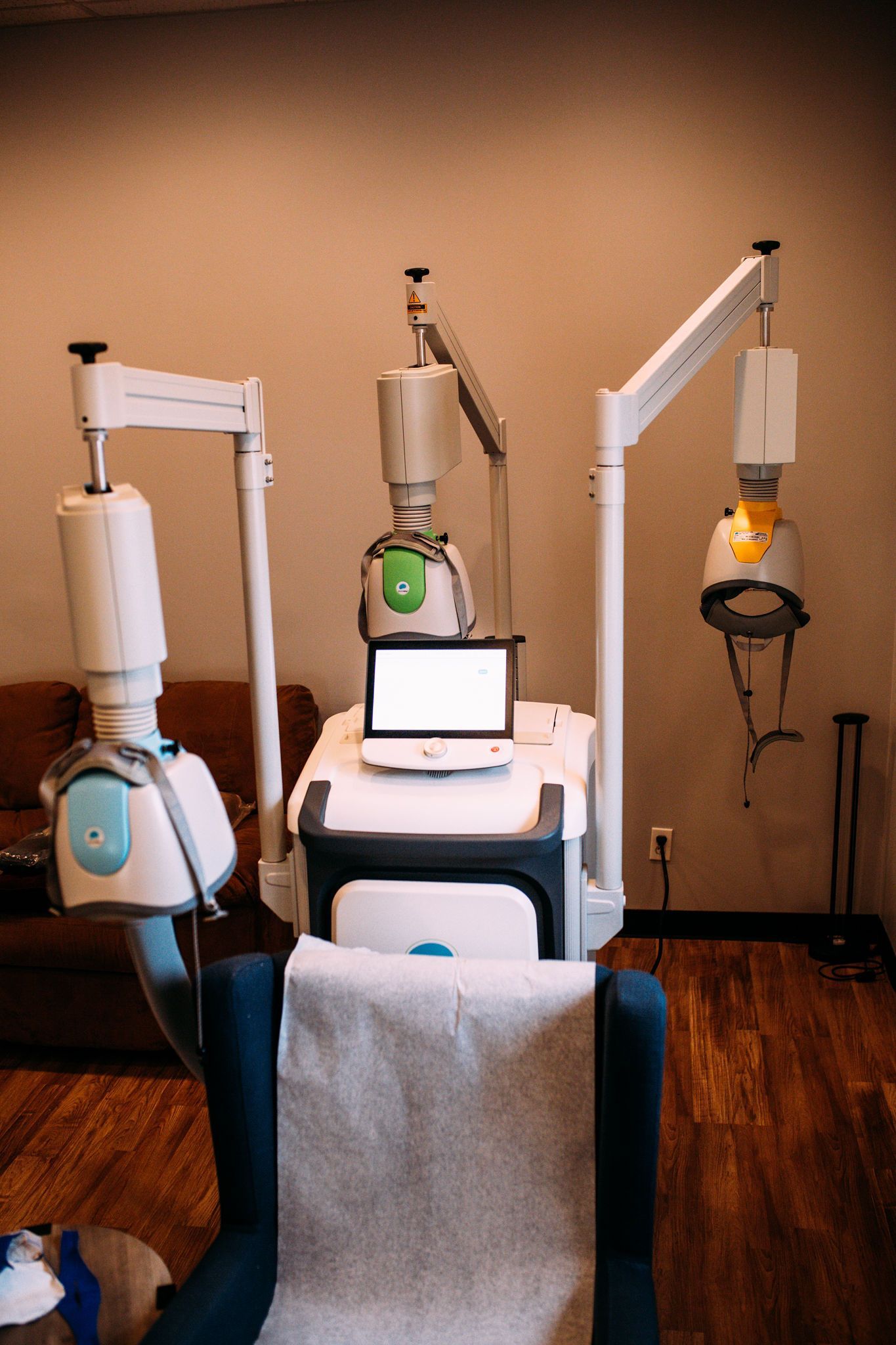 A chair is sitting in front of a machine in a room.