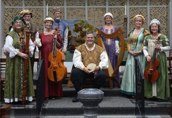 Group of people in Renaissance costumes, playing instruments.